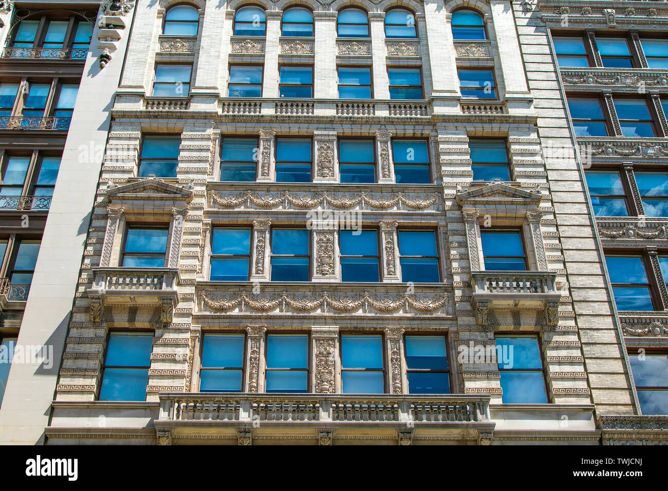 Bright blue skies are reflected in windows of a typical SoHo building. Stock Photo
