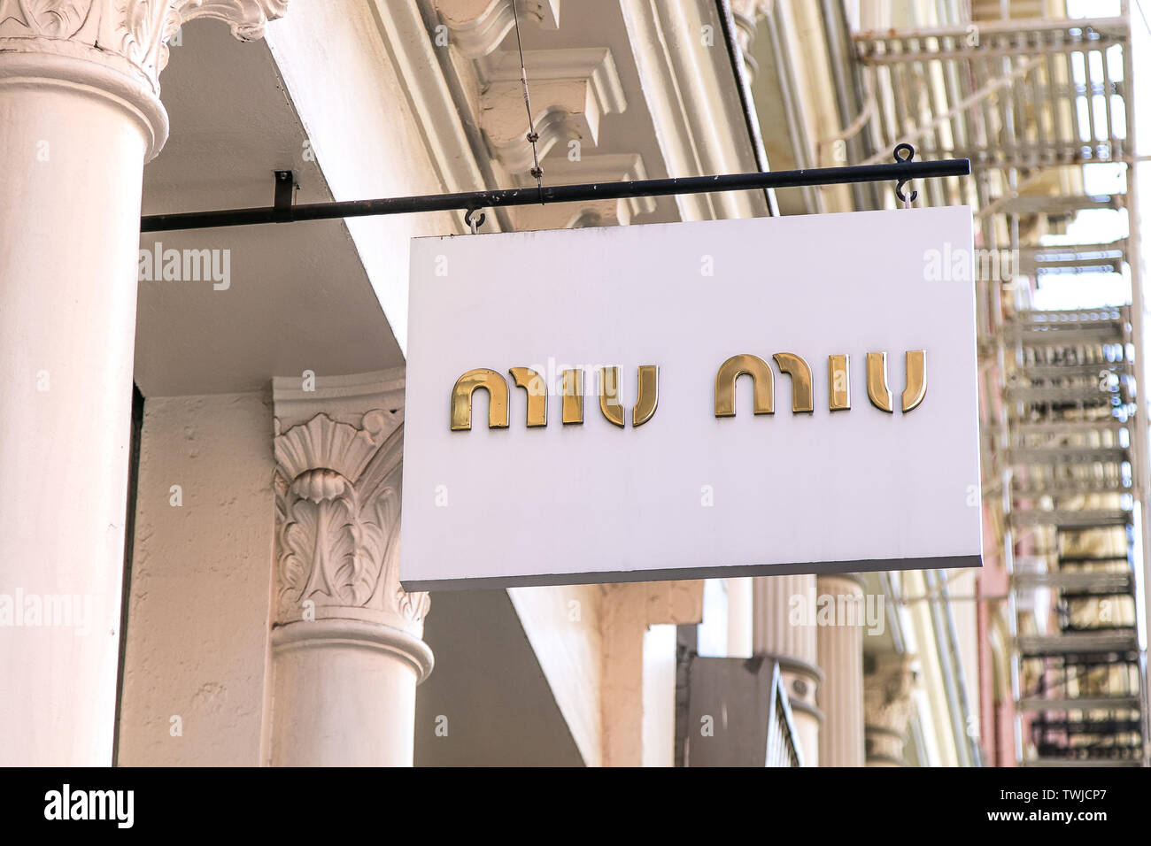 New York, 6/15/2019: Miu Miu banner is suspended near the entrance to their store  in SoHo. Stock Photo