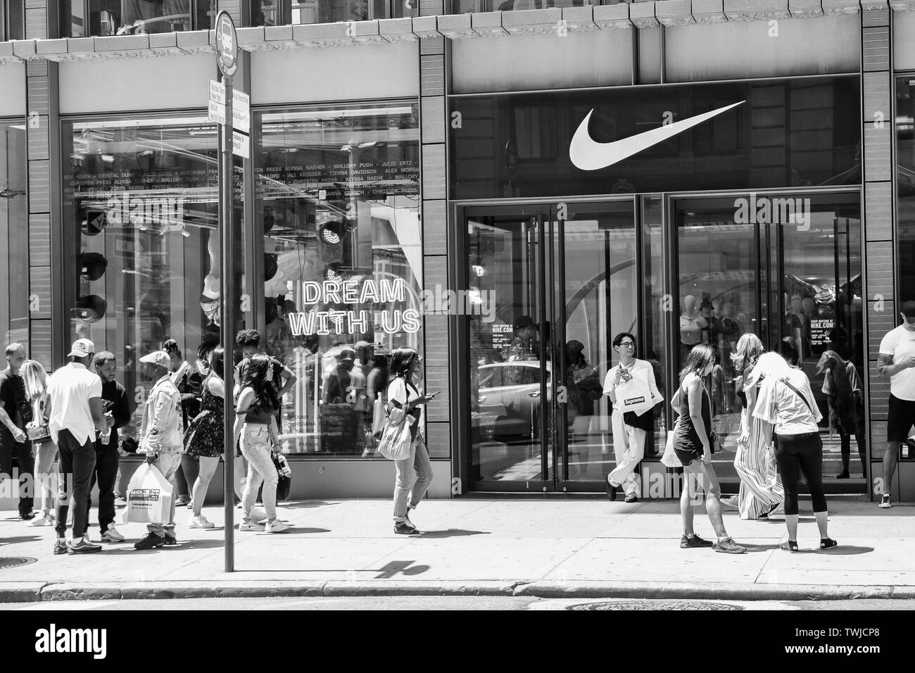 New York, 6/15/2019: People walk by a Nike store in SoHo. Stock Photo