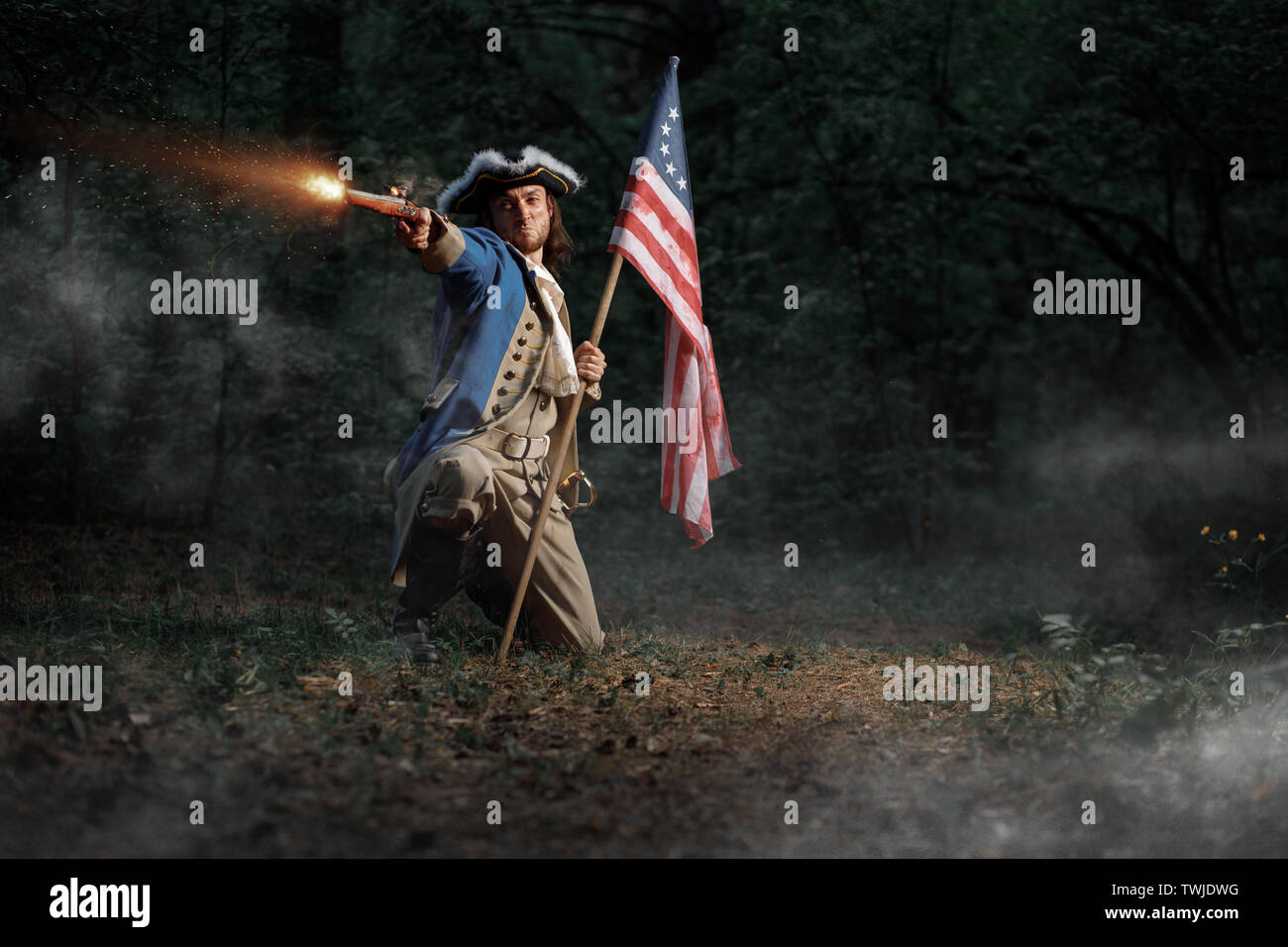 Man dressed as soldier of War of Independence United States aims from pistol with flag Stock Photo