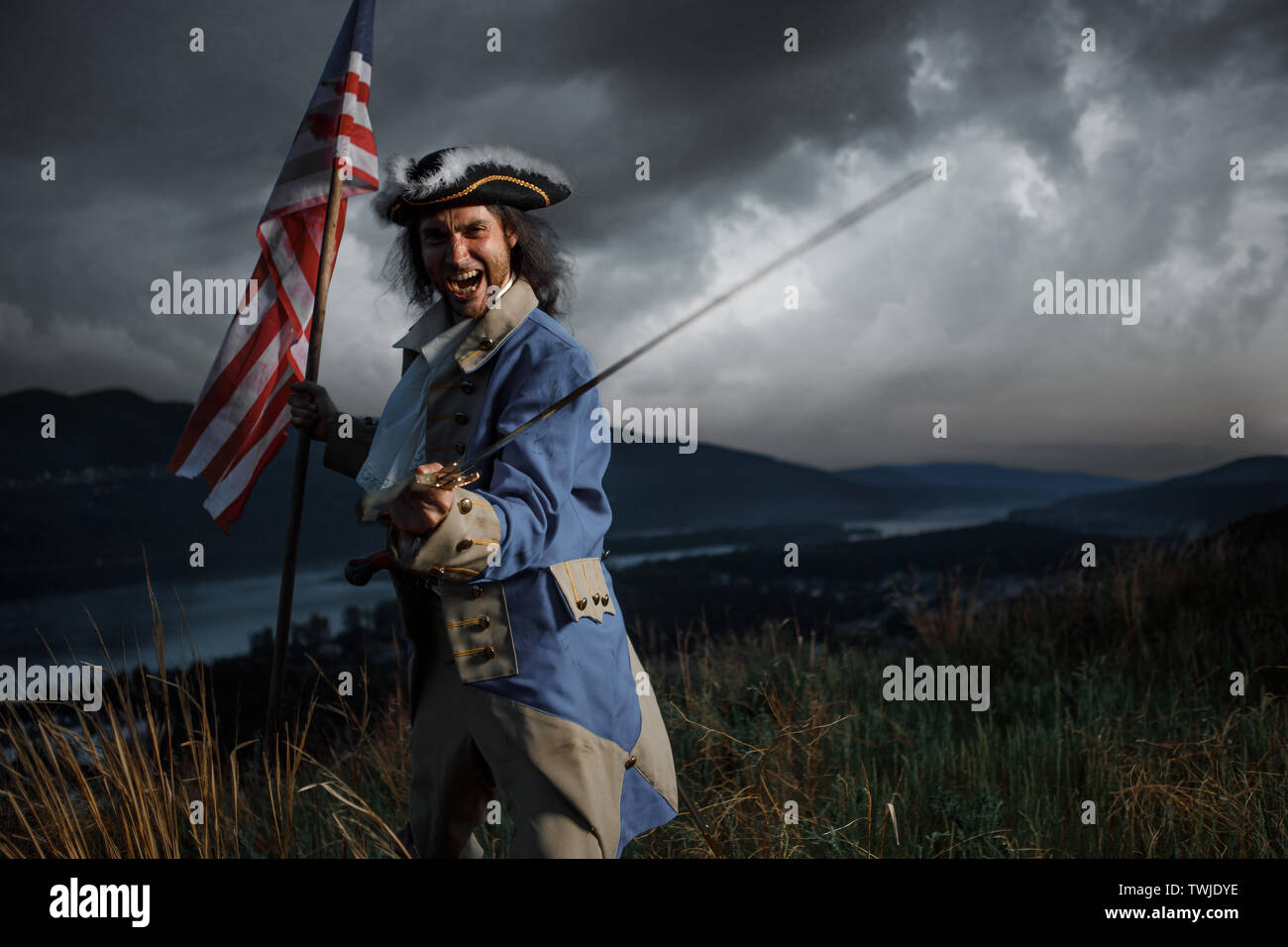 Man in United States War of Independence soldier costume with flag posing in forest. 4 july independence day of USA concept photo composition Stock Photo