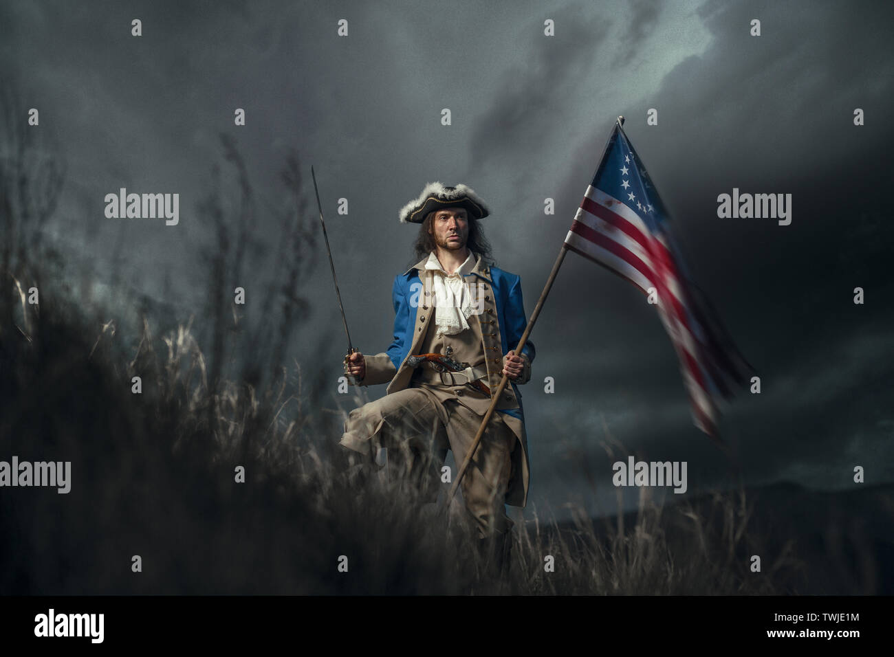 American revolution war soldier with flag of colonies and saber over dramatic landscape. 4 july independence day of USA concept photo composition: sol Stock Photo