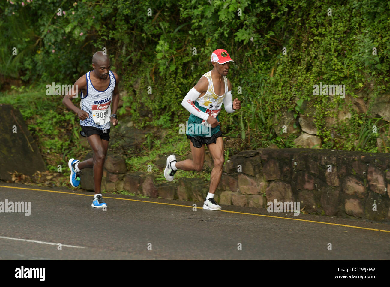 Durban, South Africa, 2 adult male elite athletes running in 2019 Comrades Marathon race, competition, sport, people, runners Stock Photo
