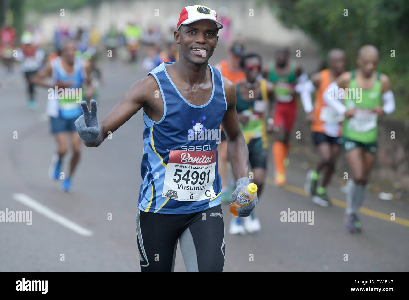 Durban, South Africa, adult man gives victory sign while running, 2019, Comrades Marathon, people, runner, athlete, people, sport, fitness Stock Photo