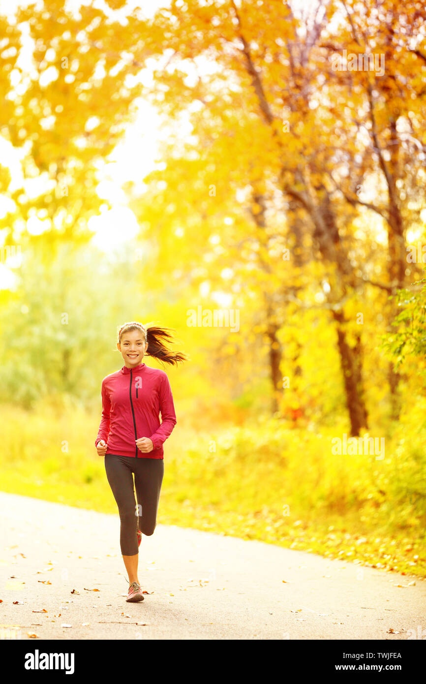 Athlete runner woman running in fall autumn forest. Female fitness girl ...