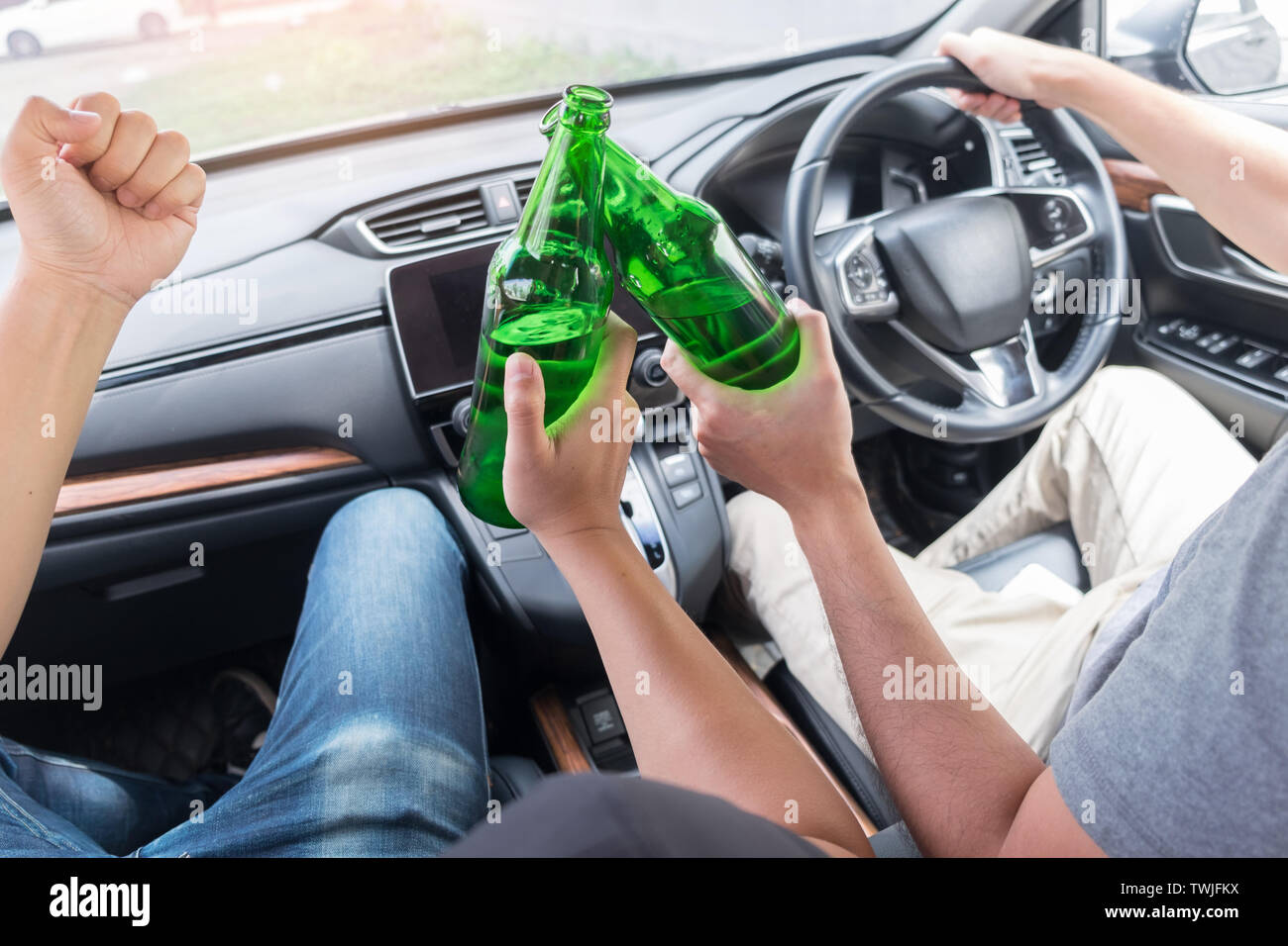 Don't Drink for Drive concept, Young Drunk man drinking bottle of beer