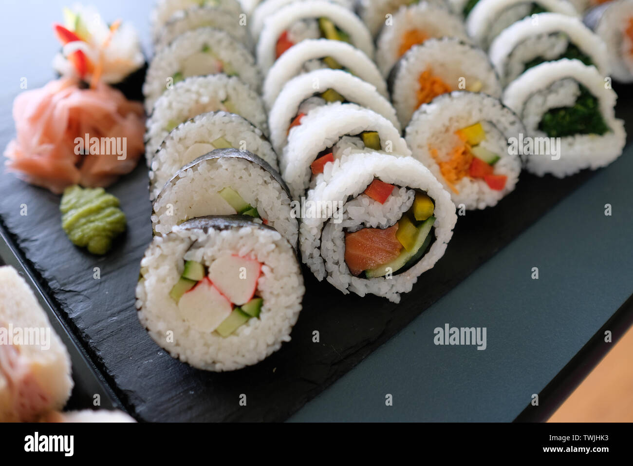 close up assorted sushi rolls, setup nicely on a table Stock Photo