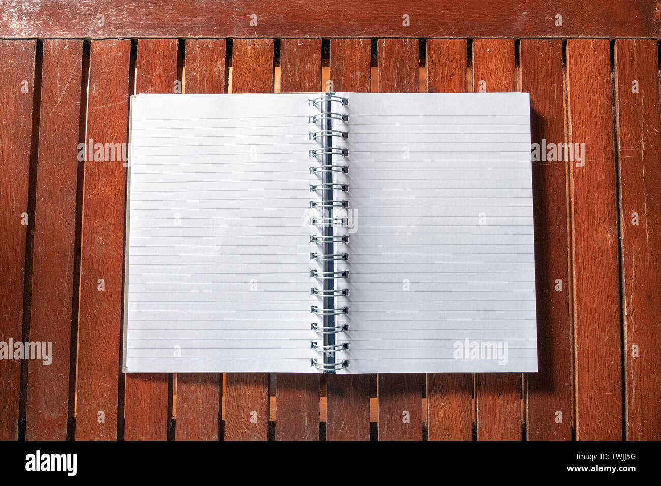 Open empty white notebook with line on wooden table Stock Photo