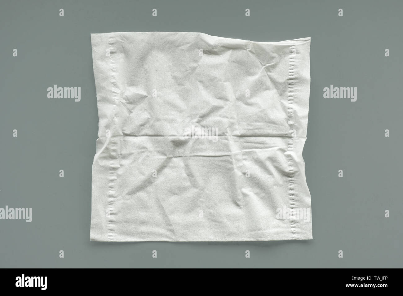Empty unused crumpled white tissue on gray background Stock Photo