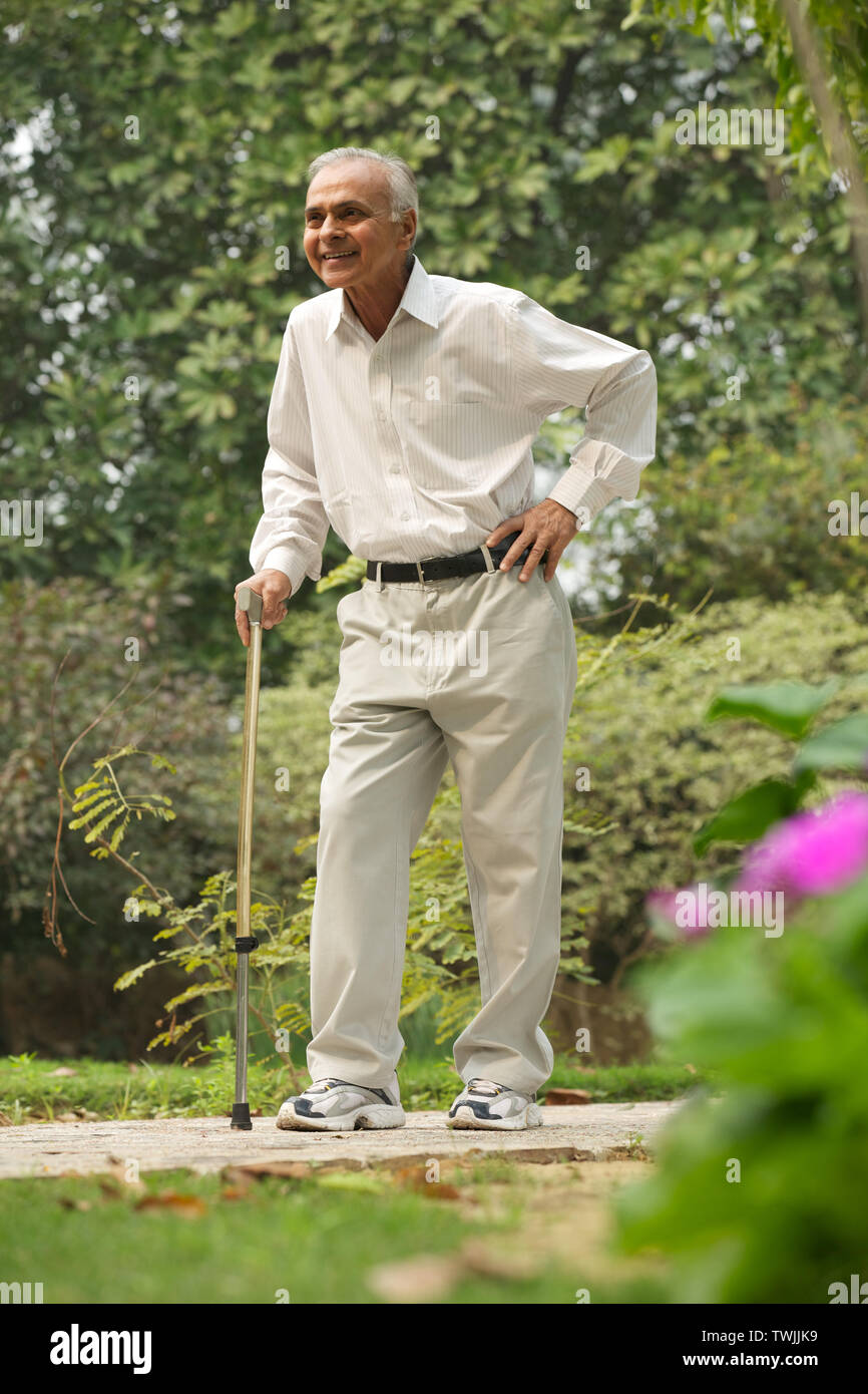 Old man walking with a cane Stock Photo Alamy