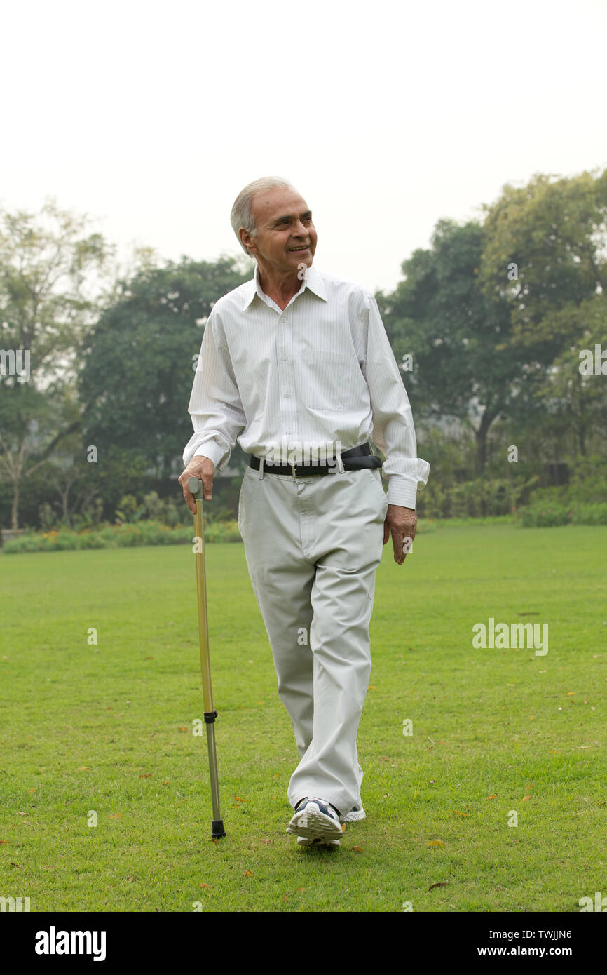 Old man walking with a cane Stock Photo - Alamy