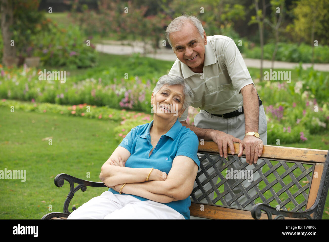 Old couple in a park and smiling Stock Photo - Alamy