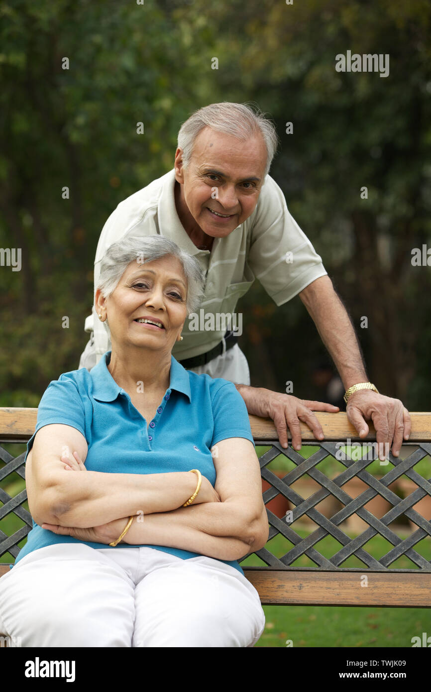 Old couple in a park and smiling Stock Photo - Alamy