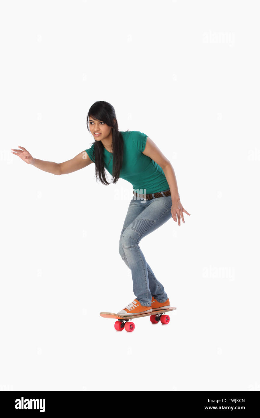 Woman skateboarding isolated on white background Stock Photo Alamy