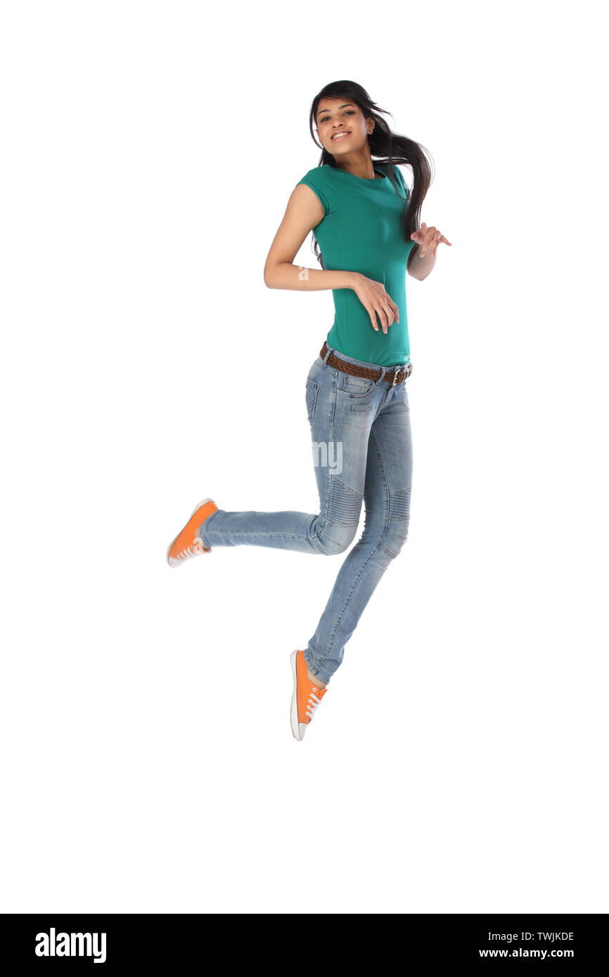 Woman jumping in air and smiling Stock Photo - Alamy