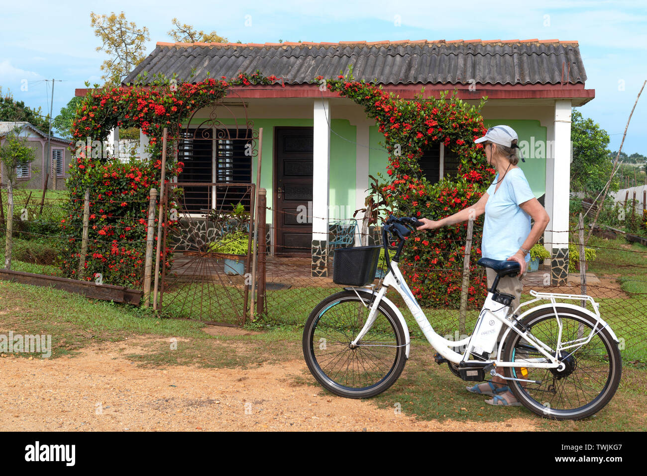 Female tourist on electric bike touring through the countryside at San Juan y Martinez, Pinar del Rio, Cuba Stock Photo