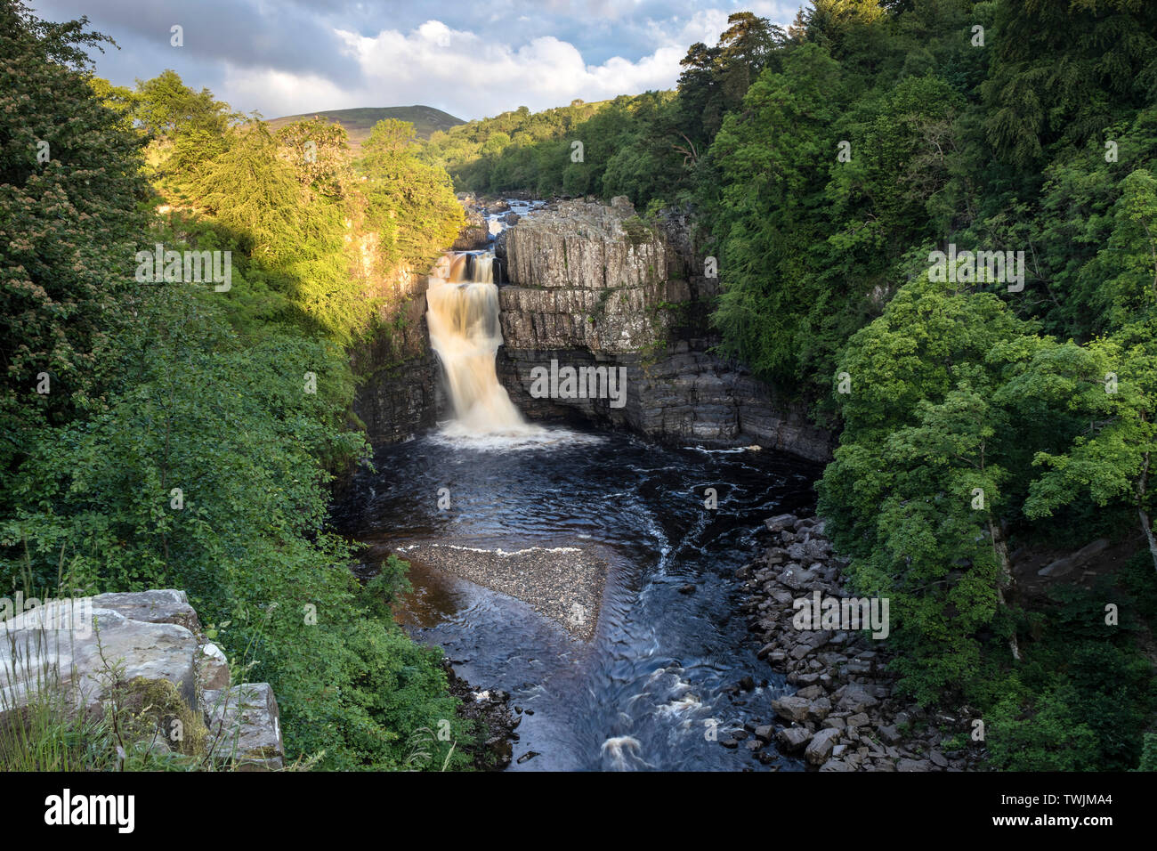 Teesdale, County Durham, UK.  21st June 2019. UK Weather.  The rising sun illuminates the River Tees at High Force on the morning of the summer solstice. Credit: David Forster/Alamy Live News Stock Photo