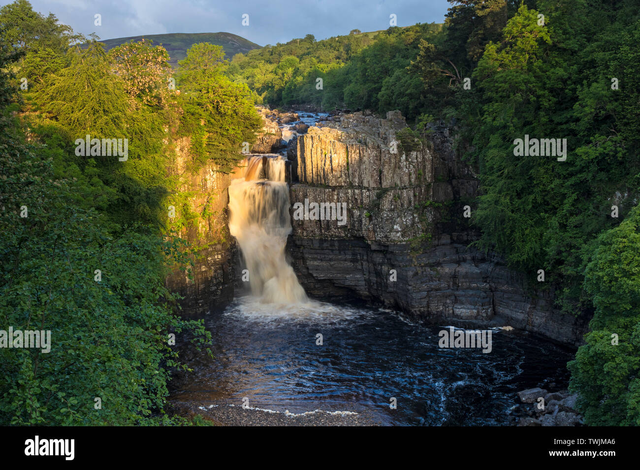 Teesdale, County Durham, UK.  21st June 2019. UK Weather.  The rising sun illuminates the River Tees at High Force on the morning of the summer solstice. Credit: David Forster/Alamy Live News Stock Photo