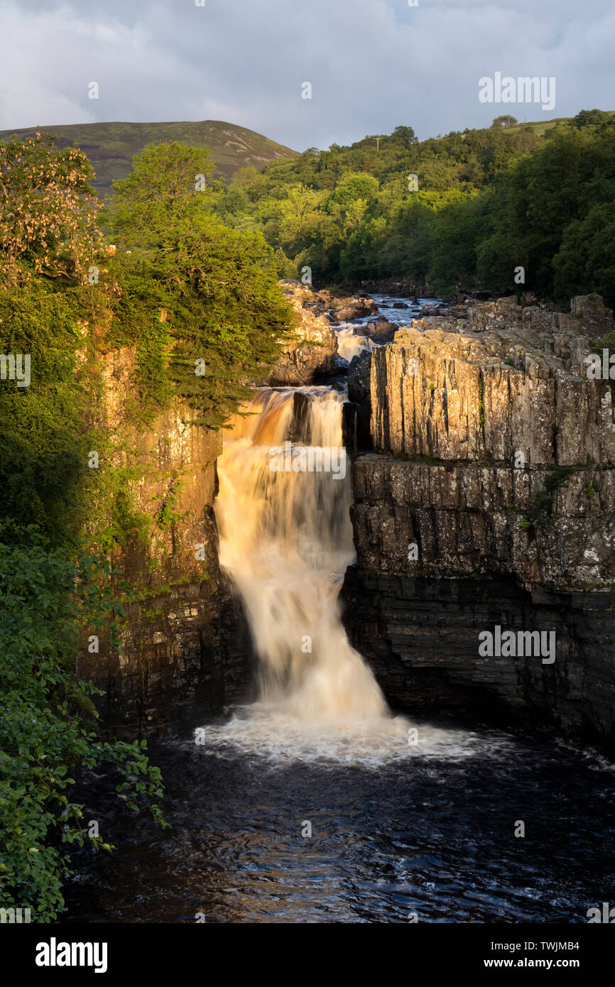 Teesdale, County Durham, UK.  21st June 2019. UK Weather.  The rising sun illuminates the River Tees at High Force on the morning of the summer solstice. Credit: David Forster/Alamy Live News Stock Photo