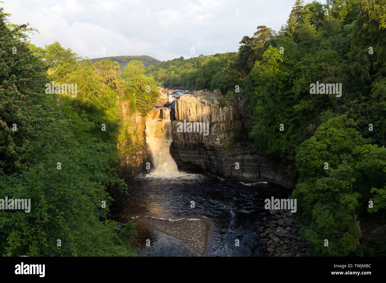 Teesdale, County Durham, UK.  21st June 2019. UK Weather.  The rising sun illuminates the River Tees at High Force on the morning of the summer solstice. Credit: David Forster/Alamy Live News Stock Photo