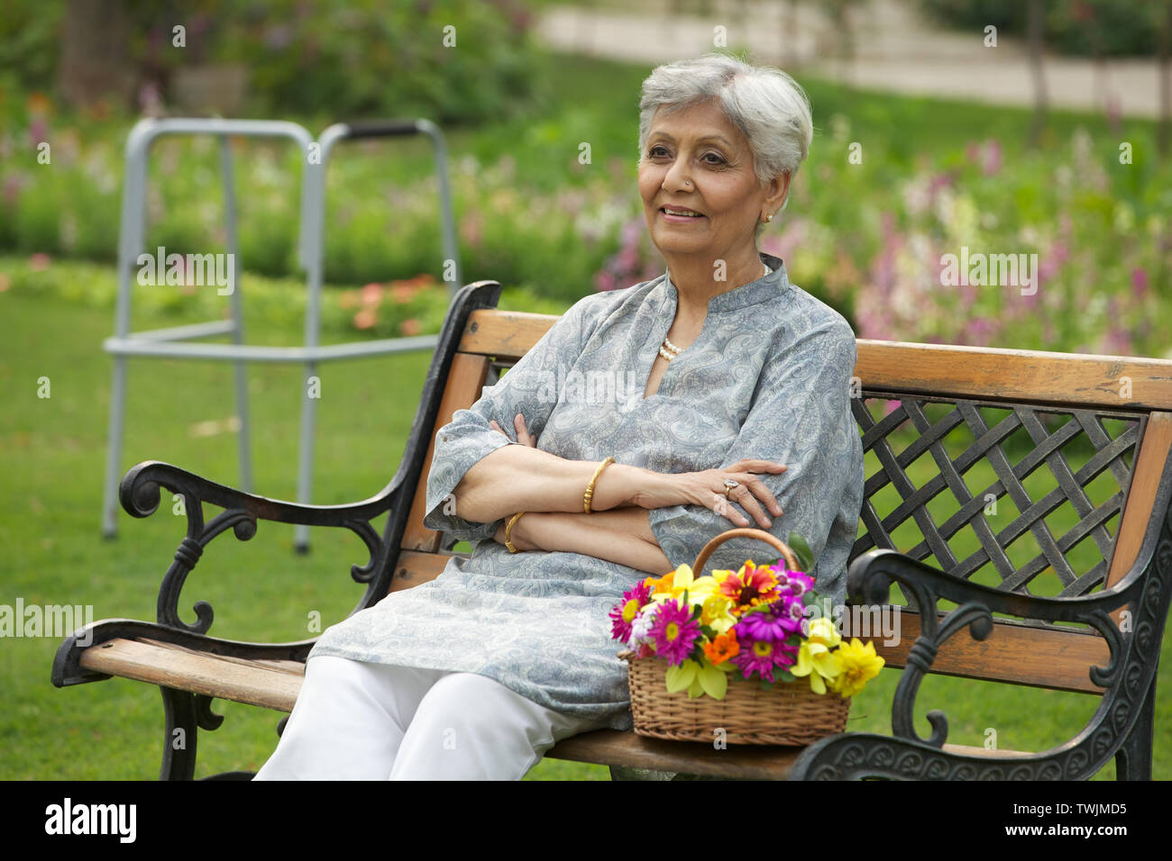 Old woman sitting on a park bench Stock Photo - Alamy