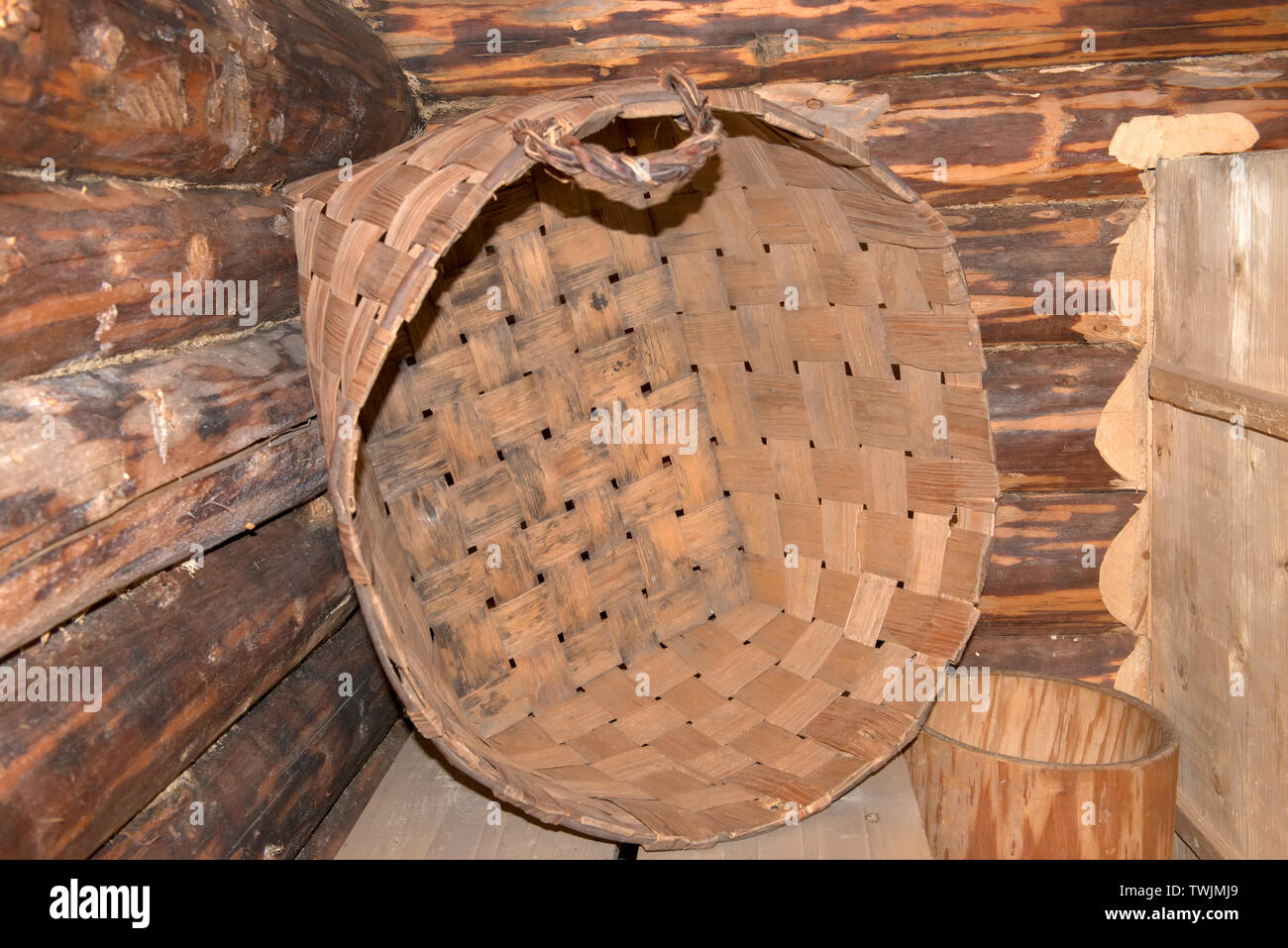 Wicker basket in the interior of an old peasant hut Stock Photo