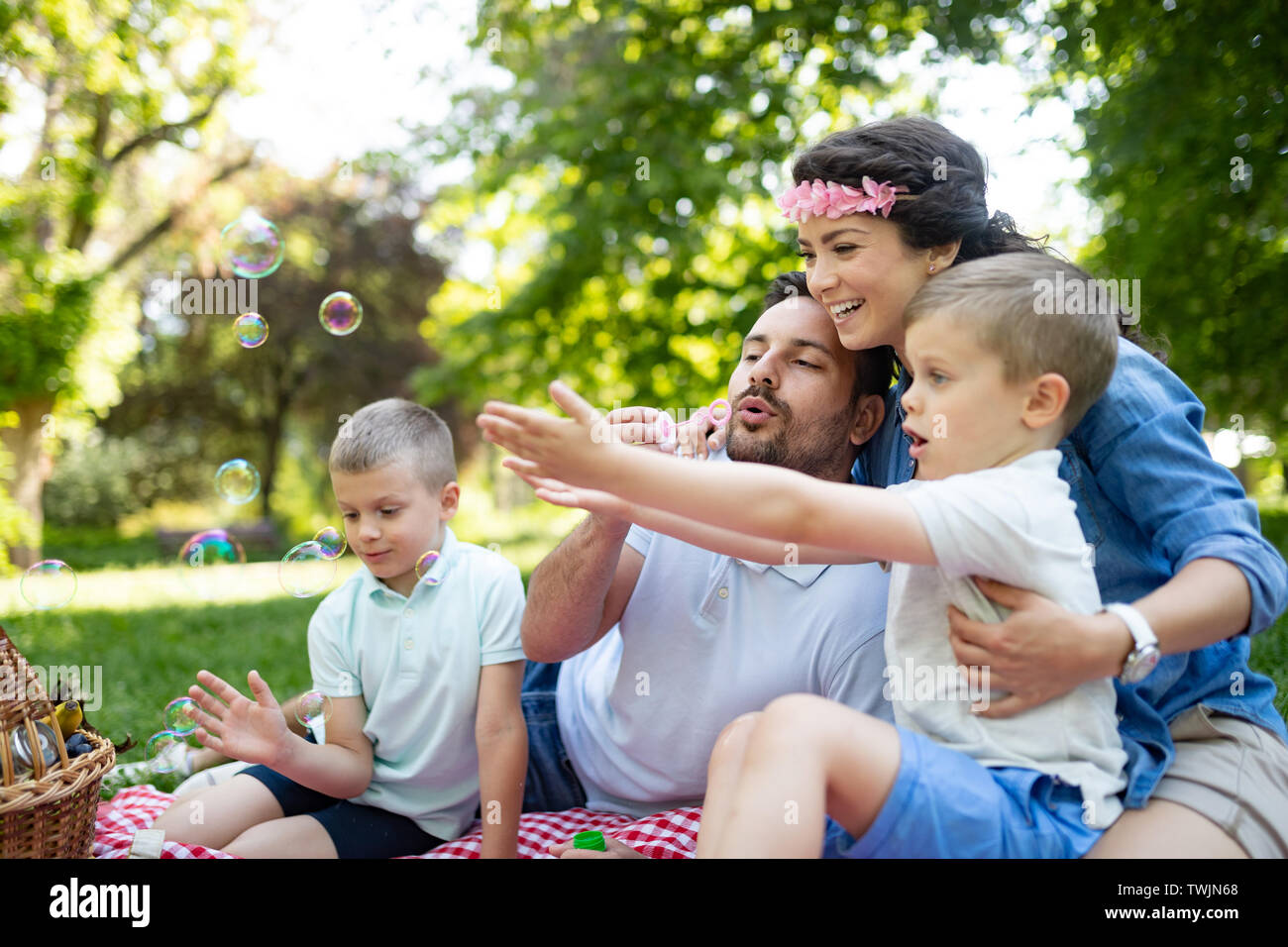 Family with children blow soap bubbles outdoors Stock Photo - Alamy