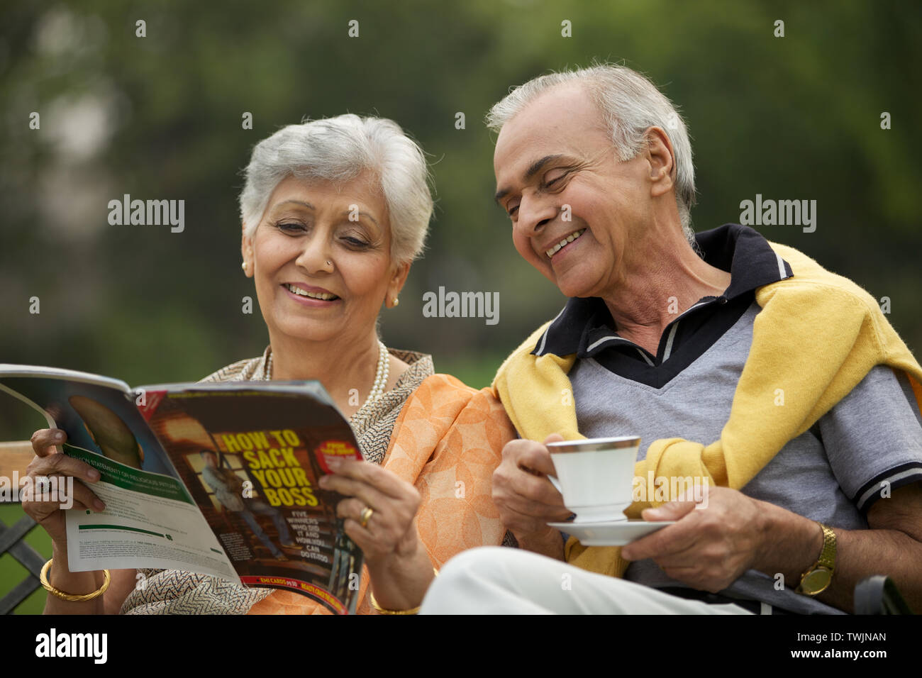 Old couple reading a magazine Stock Photo