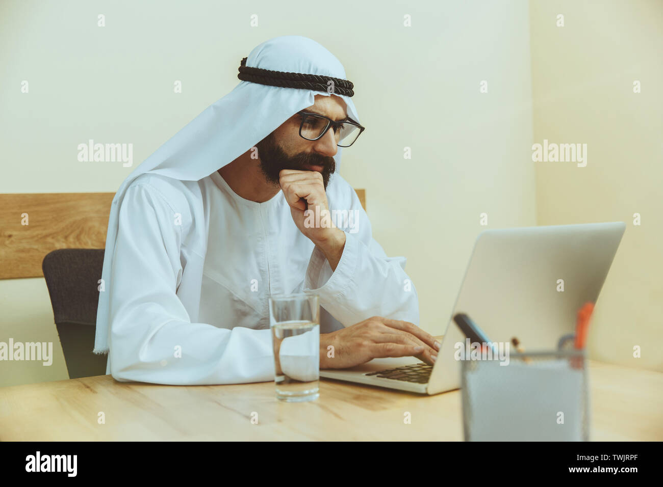 Arab saudi businessman working online with a laptop and tablet in his