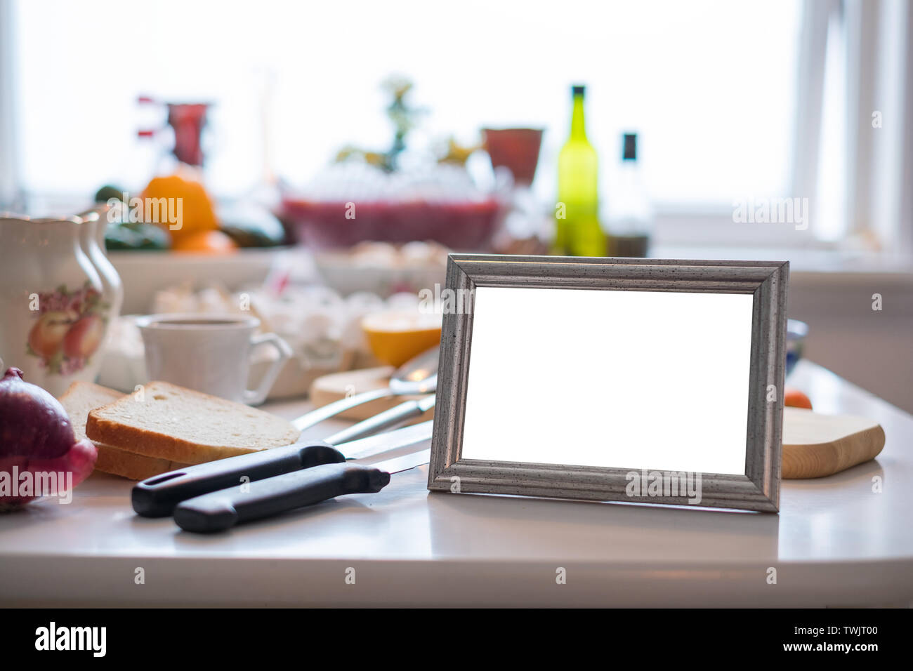 Blank picture frame with ingredient cooking on dining table Stock Photo ...