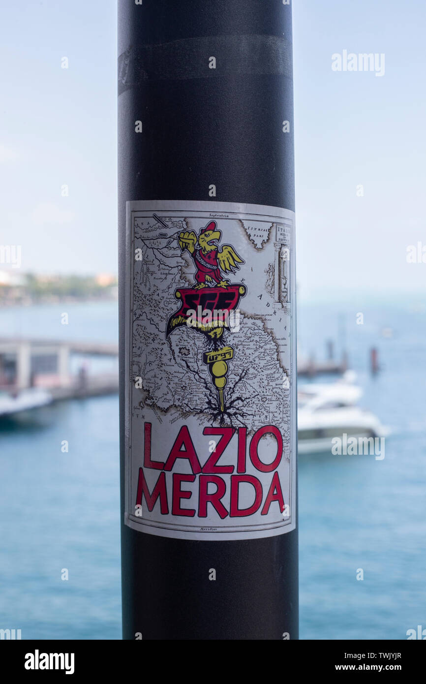 A 'Lazio Merda' sticker on a lamp post in Peschiera del Garda, northern Italy. Stock Photo
