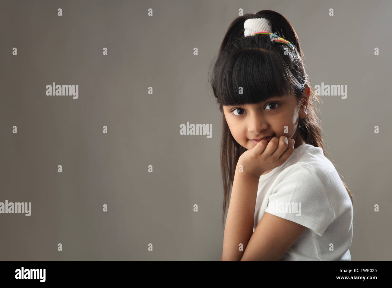 Hand on chin girl thinking hi-res stock photography and images - Alamy
