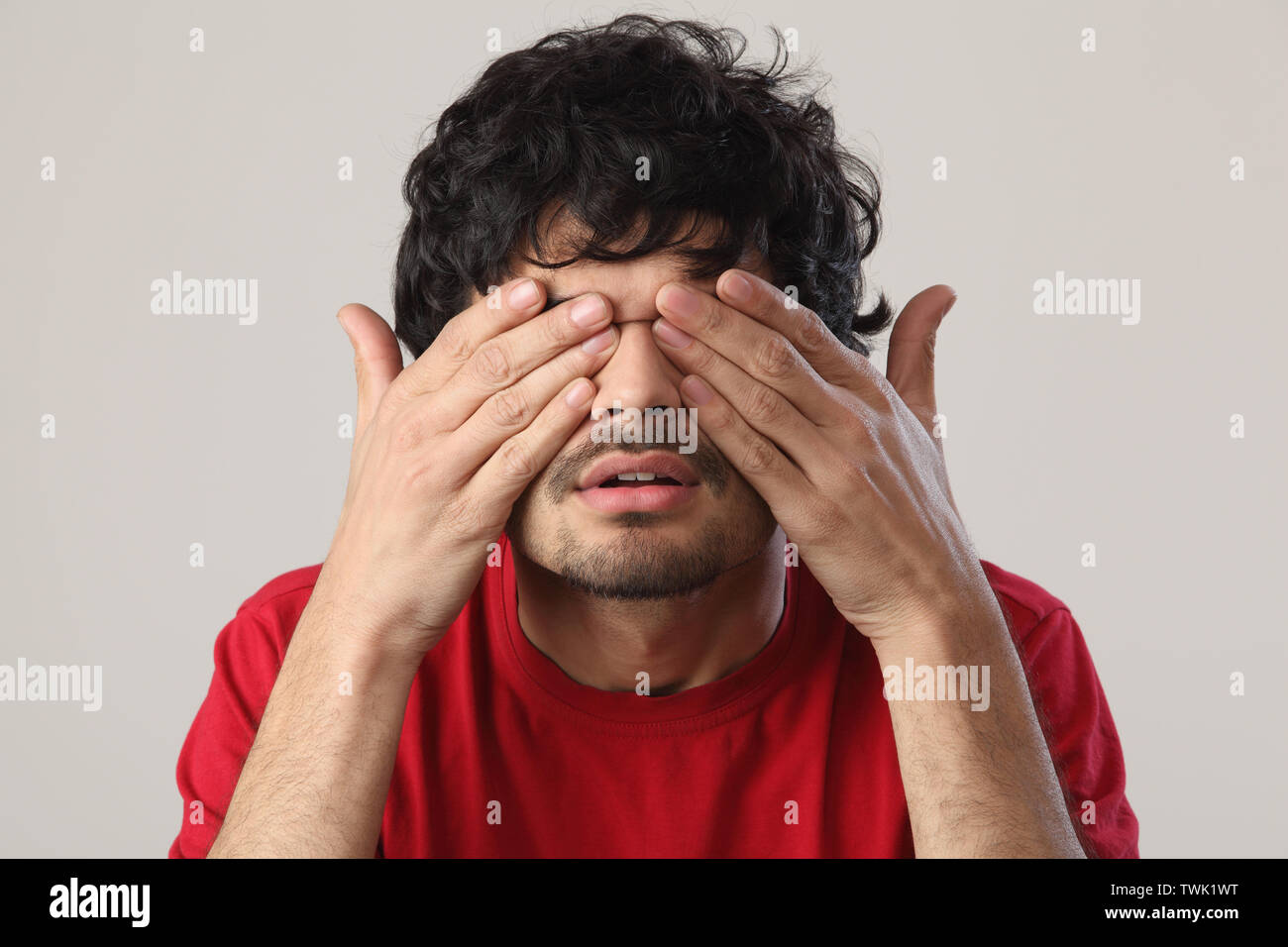 Man covering eyes with hands Stock Photo - Alamy
