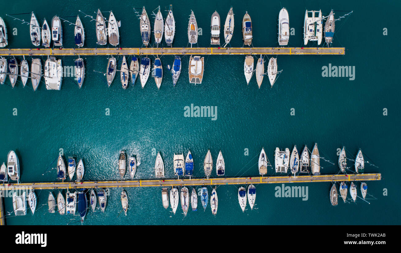 Aerial view of yachts and boat berthed in the marina and clear water ...