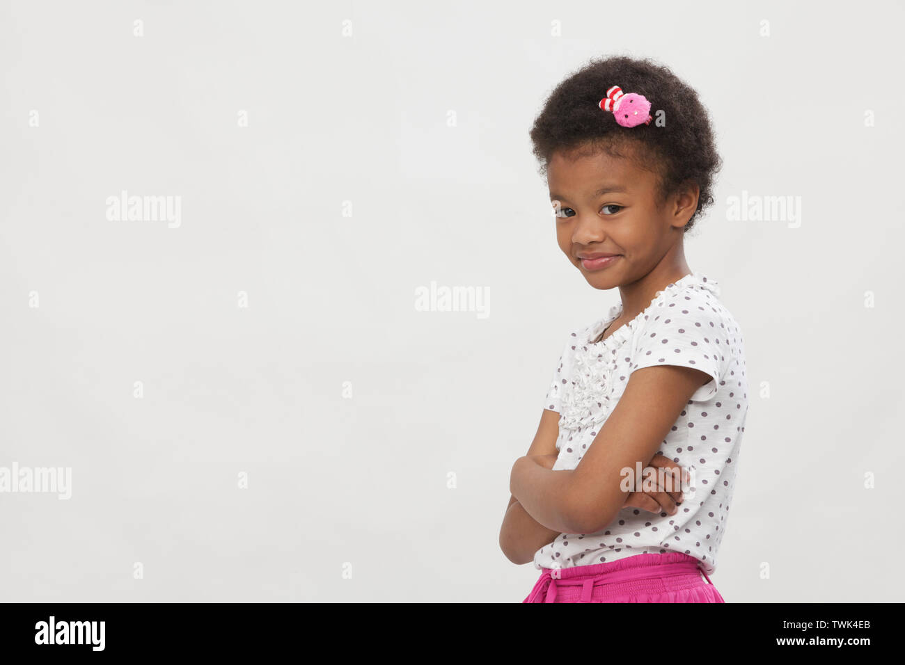 Portrait of a girl standing with arms crossed Stock Photo