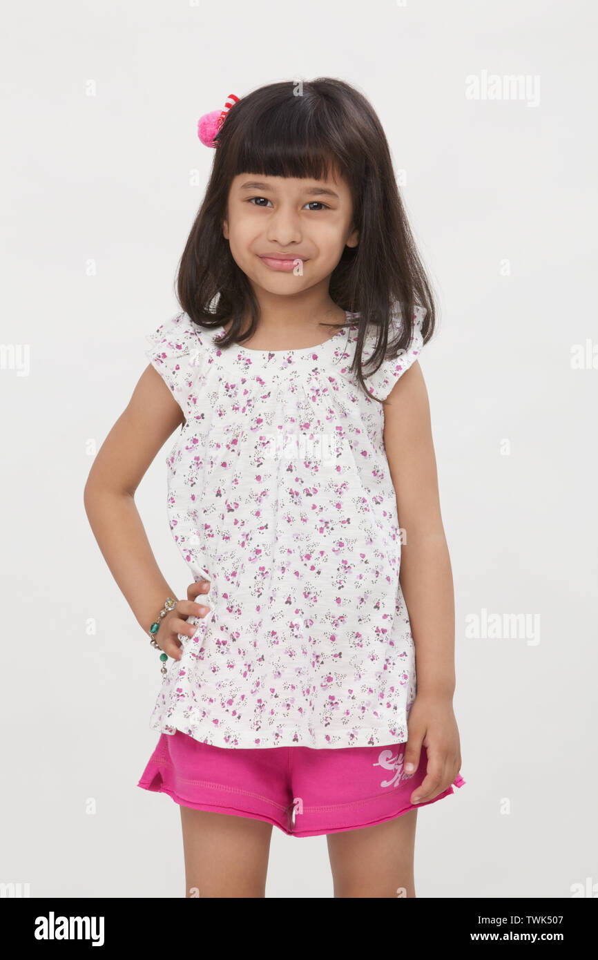 Portrait of a girl standing with hand on hip Stock Photo - Alamy