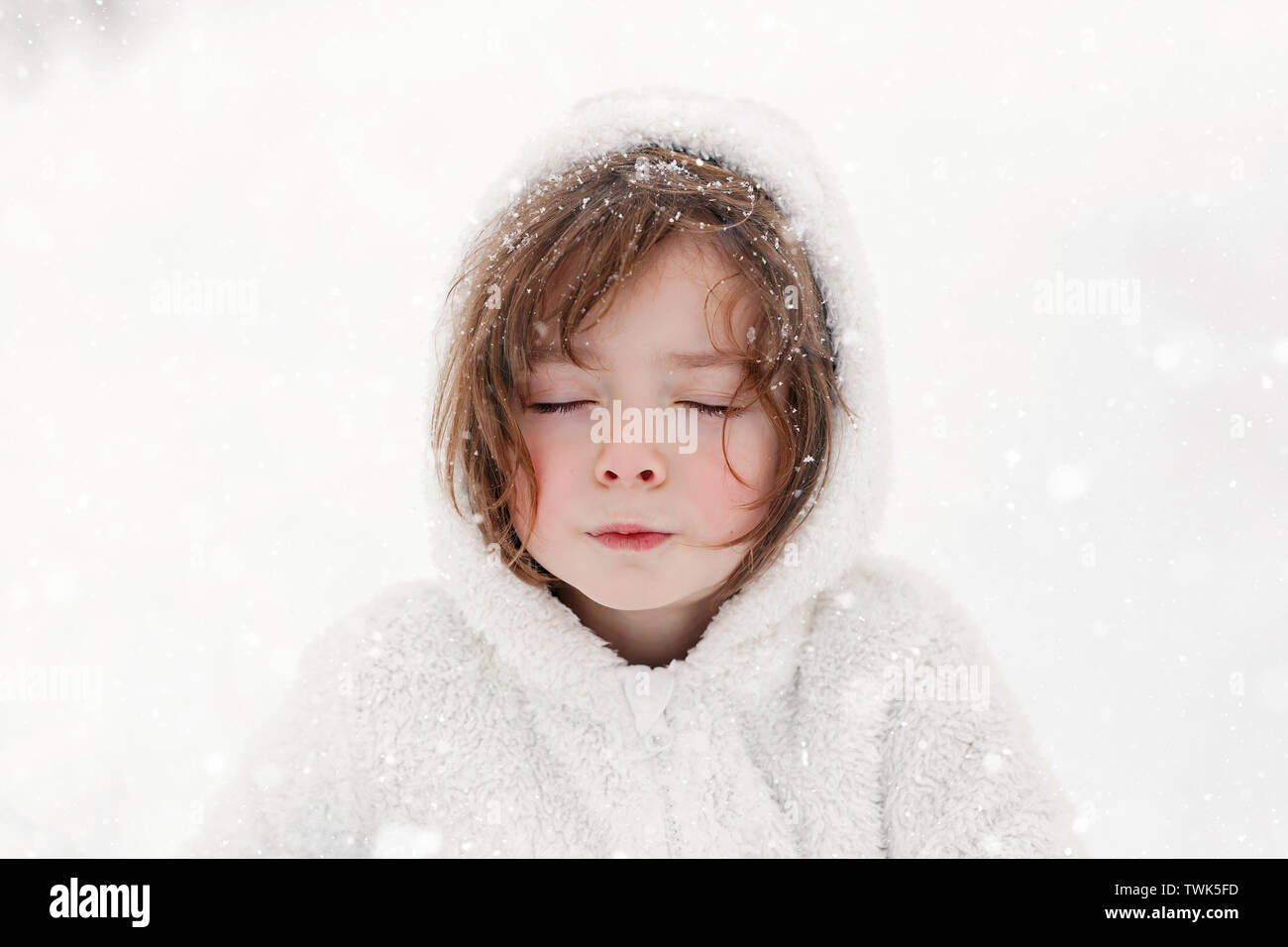 5 year old boy playing outside in the snow. Stock Photo