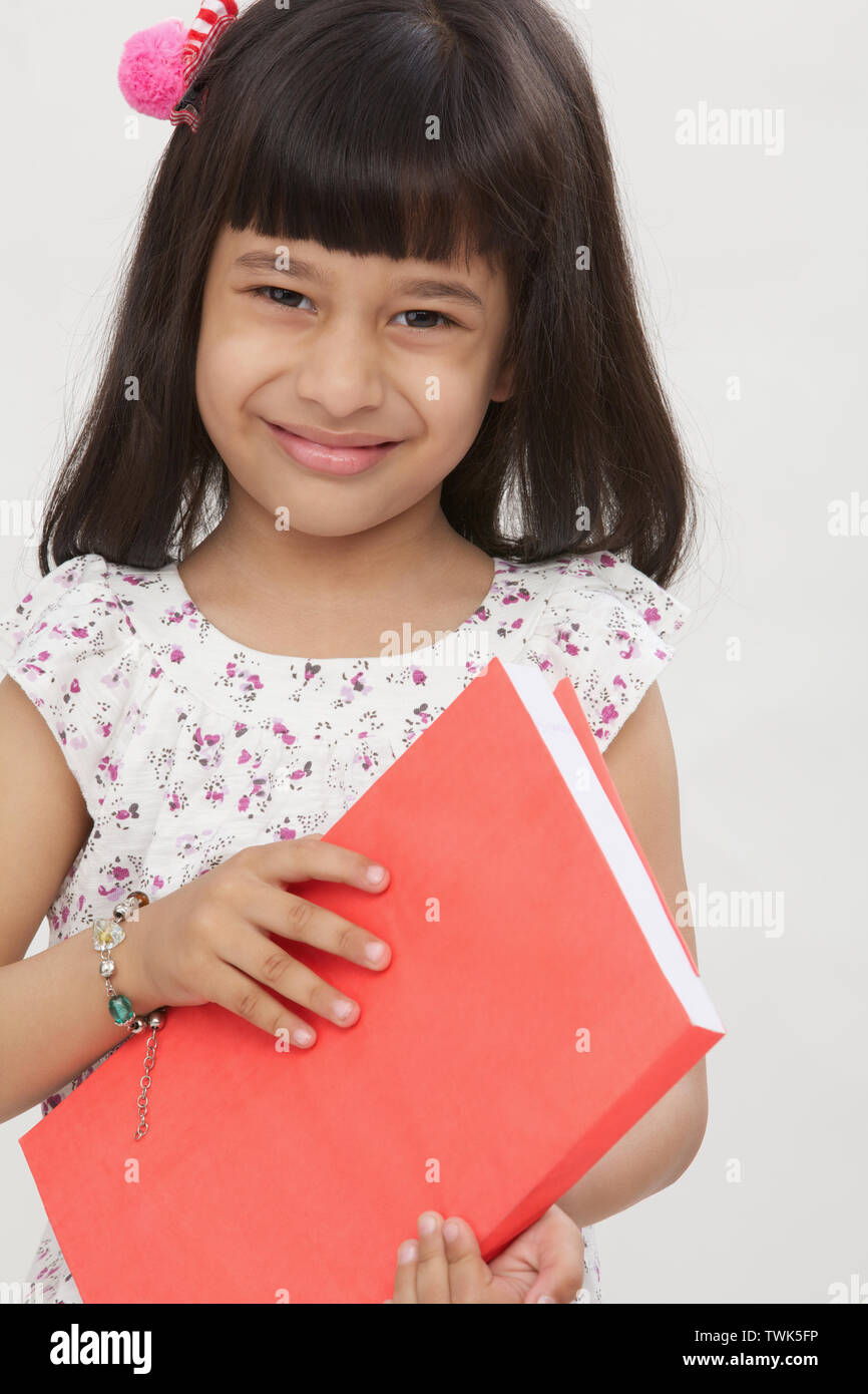 Portrait indian girl holding book hi-res stock photography and images ...