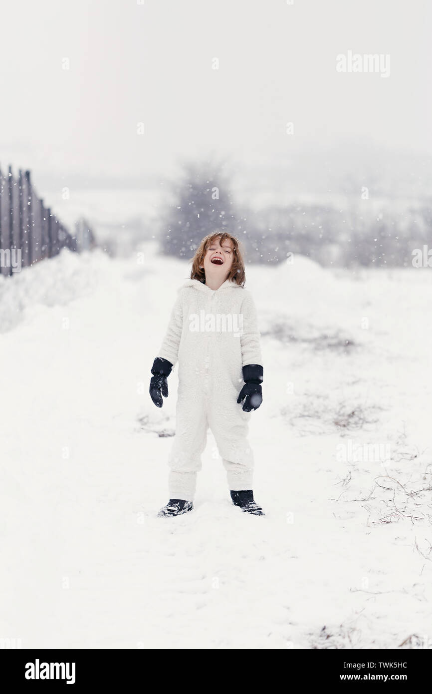 5 year old boy playing outside in the snow. Stock Photo