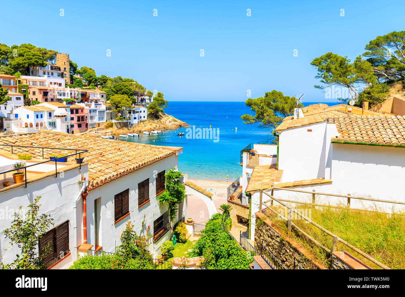 White houses with orange tile roofs and steps to beach in Sa Tuna