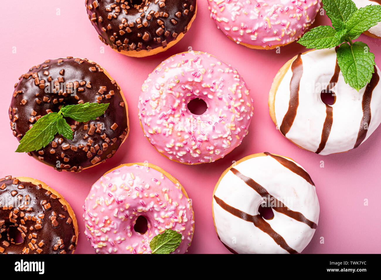 Colorful donuts on rose background Stock Photo - Alamy