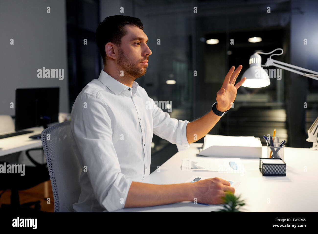 businessman using gestures at night office Stock Photo
