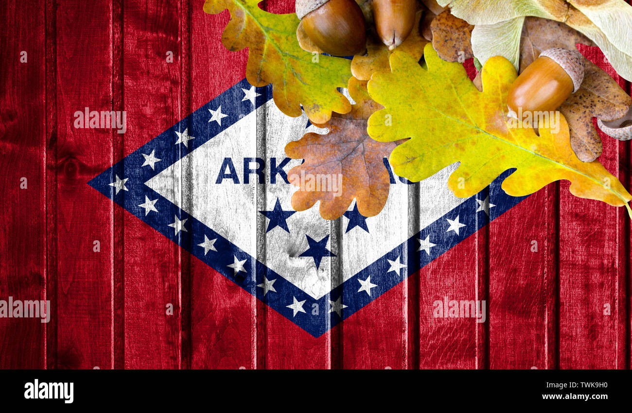 State of Arkansas flag on autumn wooden background with leaves and good ...