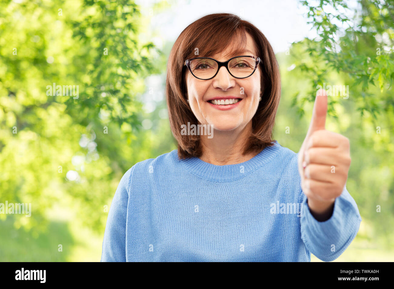 portrait of senior woman showing thumbs up Stock Photo - Alamy