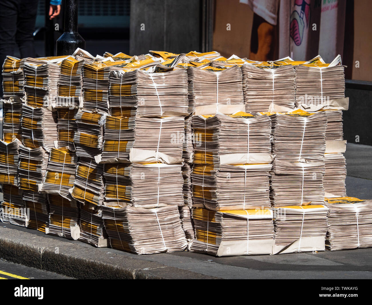 Evening Standard newspapers bundled for distribution in London. Pile of Newspapers. Stock Photo