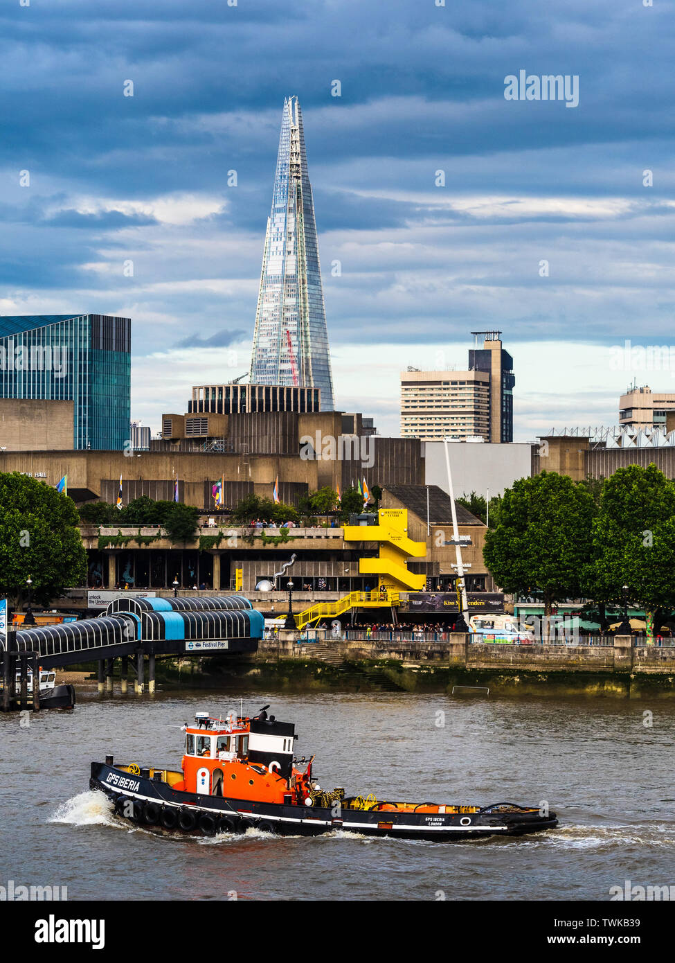 River Thames Tugboat on the Thames with the Shard in the distance Stock Photo