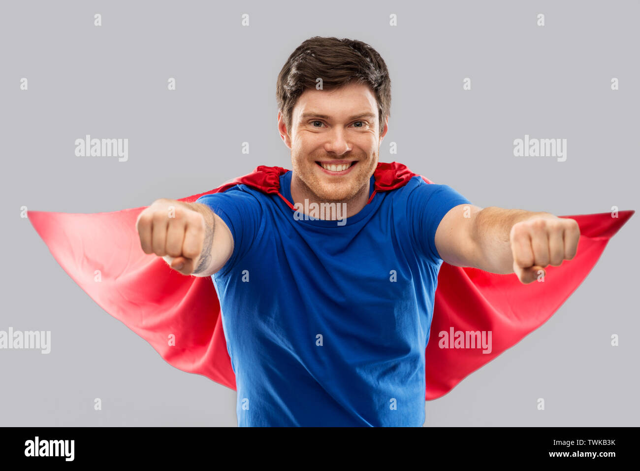 man in red superhero cape over grey background Stock Photo - Alamy