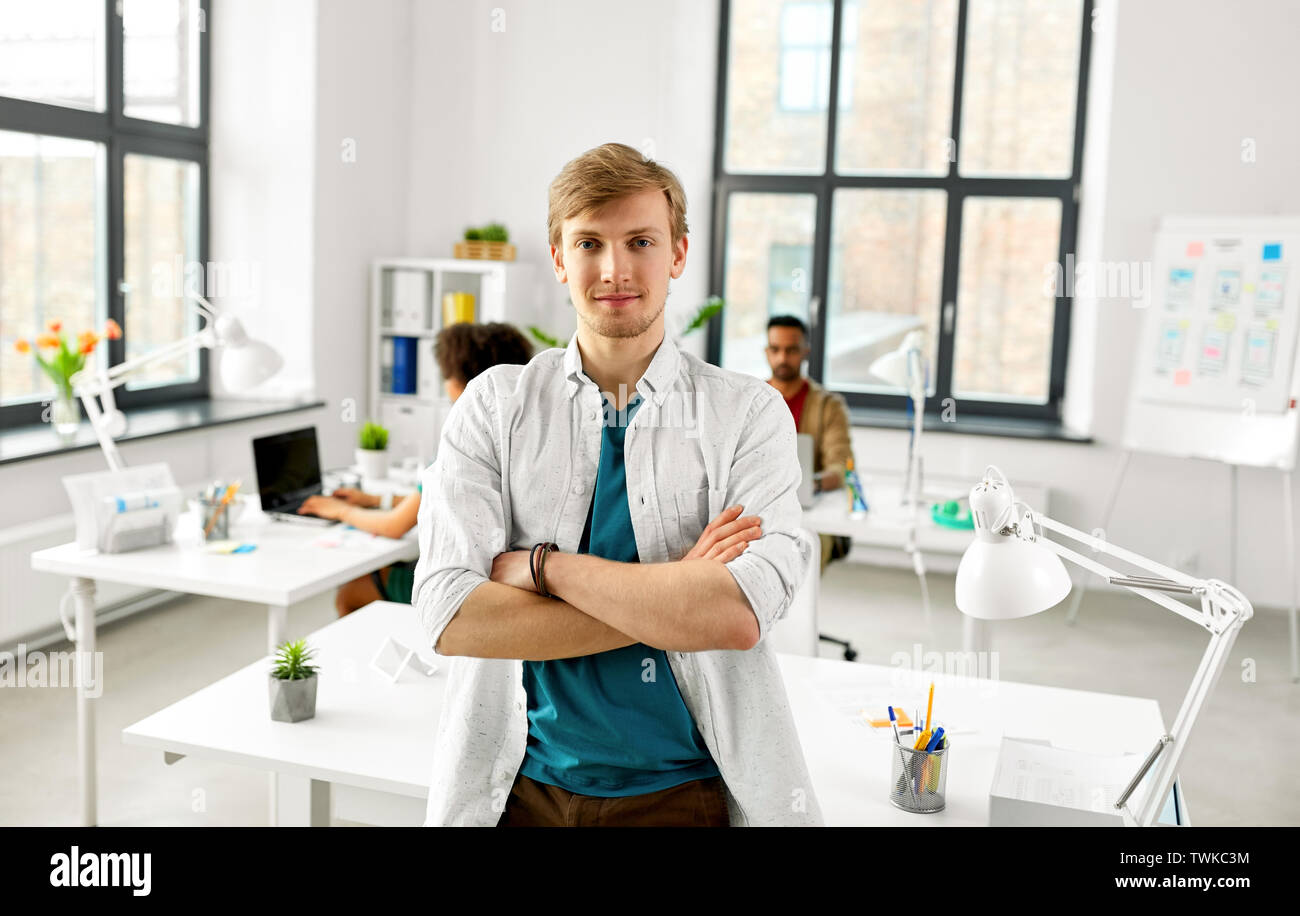 man with crossed hands at office Stock Photo Alamy