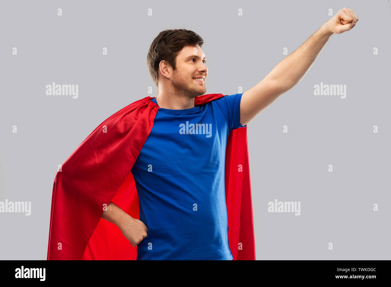 man in red superhero cape over grey background Stock Photo - Alamy