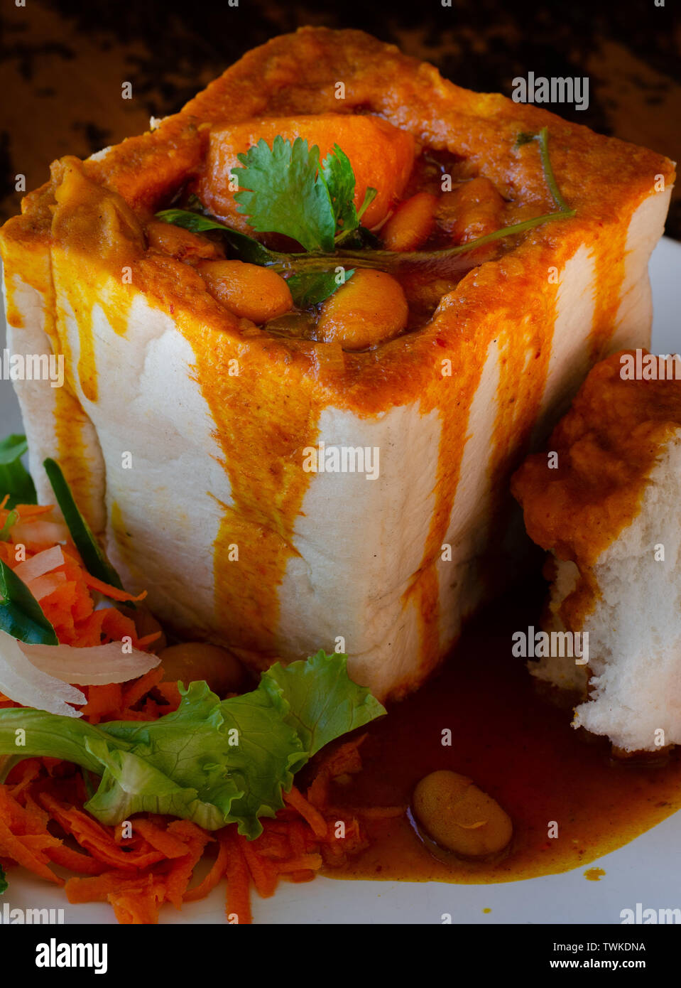 A Durban Bunny Chow or in this case a vegerarian quarter bean bunny served with sambals. The